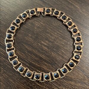 Gold linked statement necklace with black stones